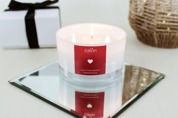 A large Black Pomegranate 3-wick candle scented candle from Welsh candle company, Calon Home.
