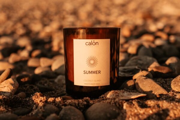 Coconut Island summer candle in sand